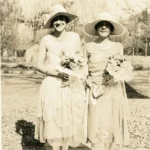 two women hold flowers