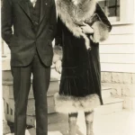 Couple dressed up outside of home