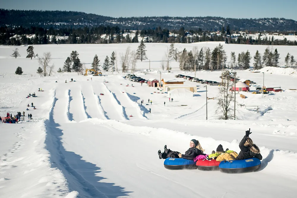 Group of friends and family snow tubing