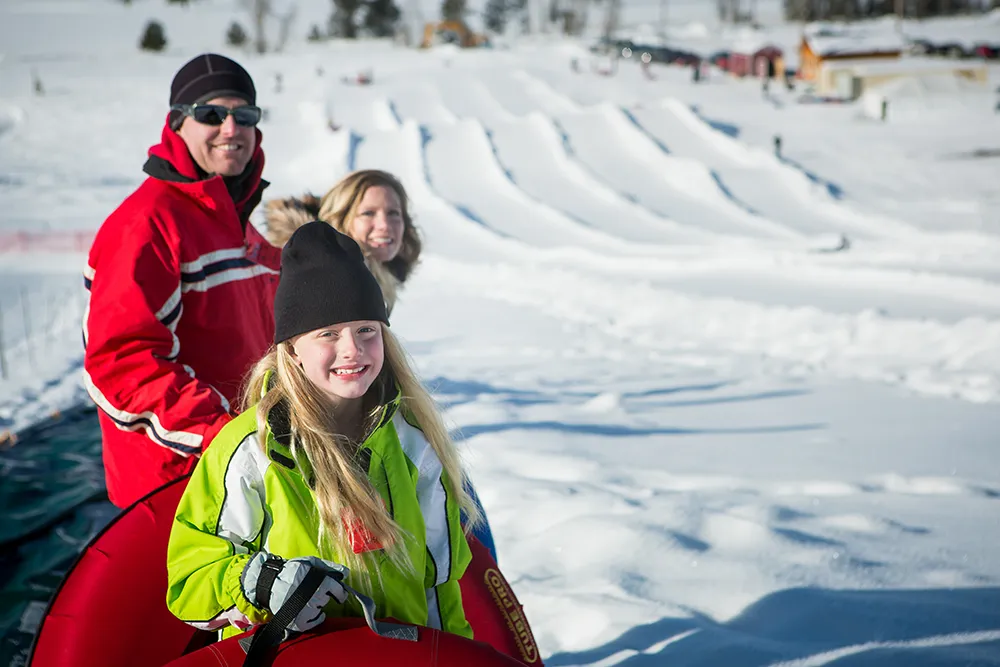 family waiting to snow tube