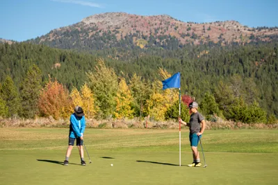 Two young kids golfing