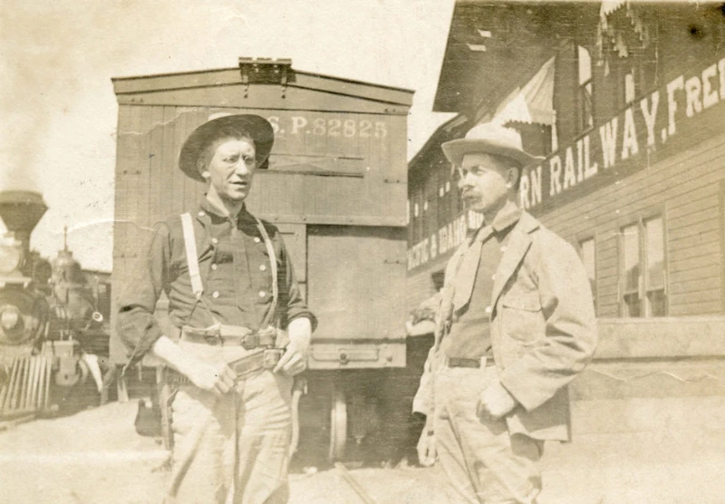 Two men at a train station