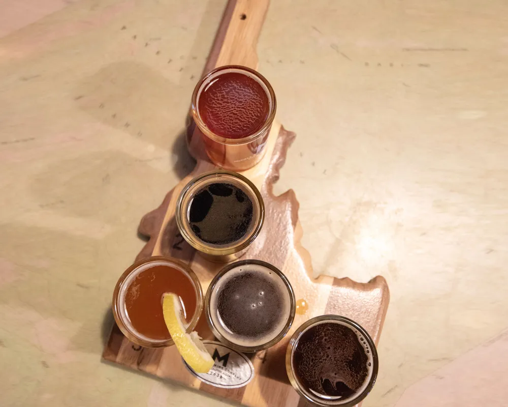 set of beer tastings on a wood cutout of Idaho