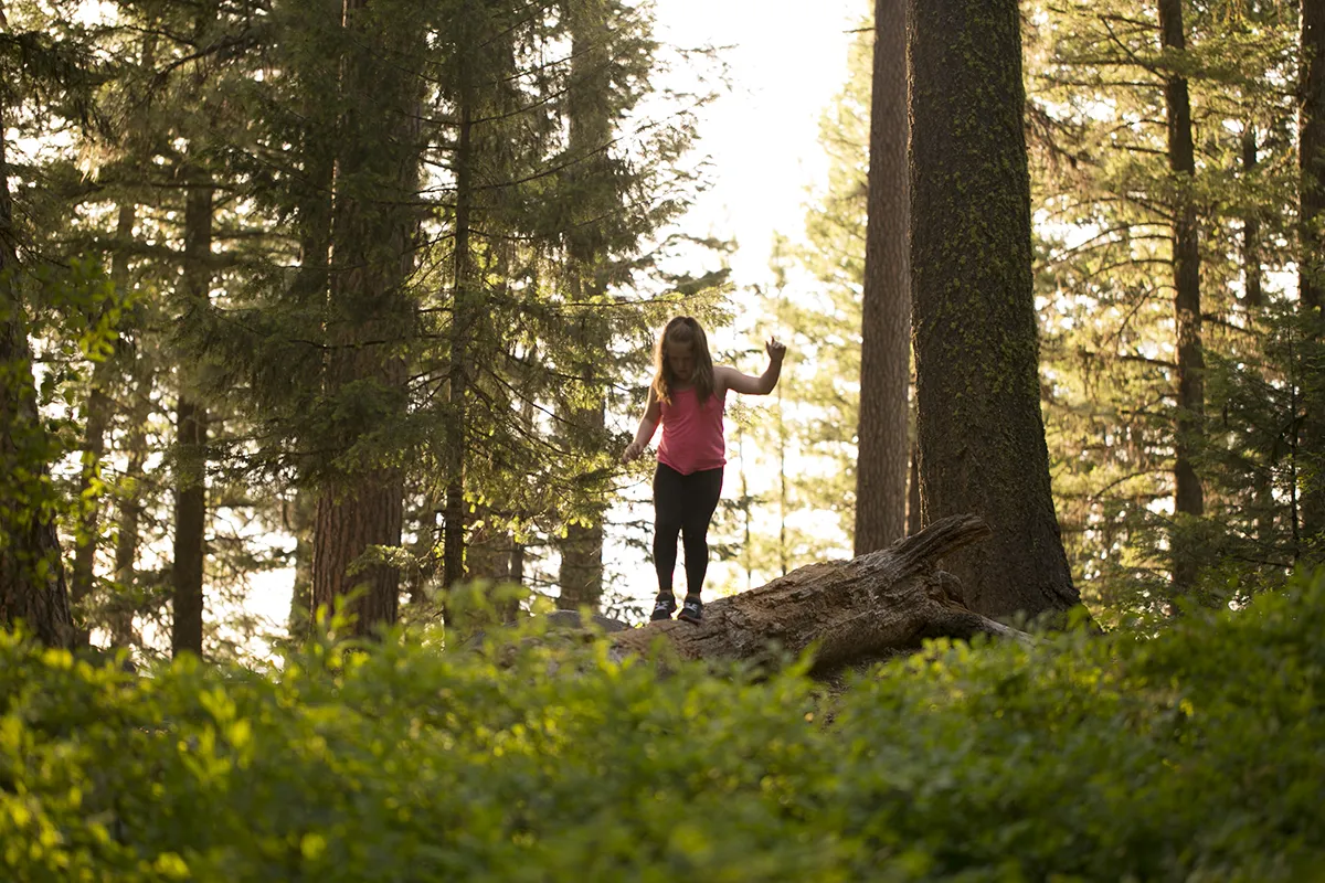 Child playing on log in Ponderosa State Park