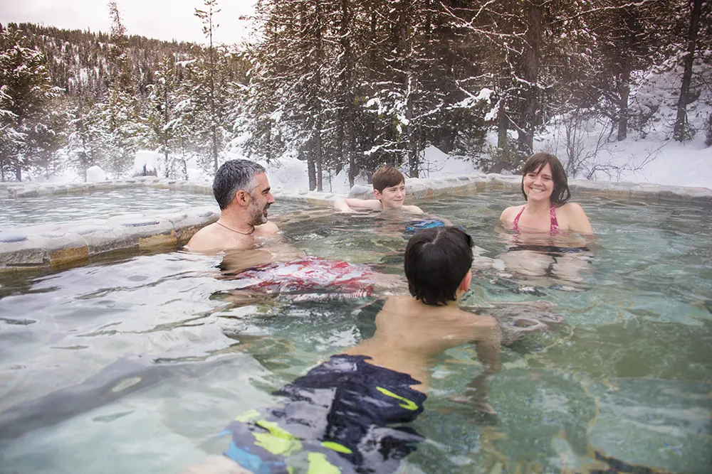 family relaxing in Gold Fork hot spring pool