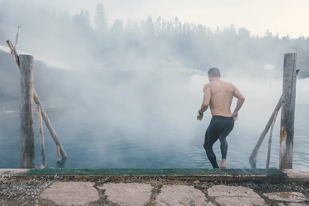 man getting into Burgdorf hot spring pool