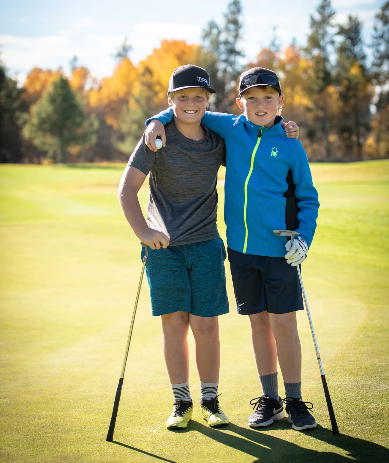 two boys embracing after golf game