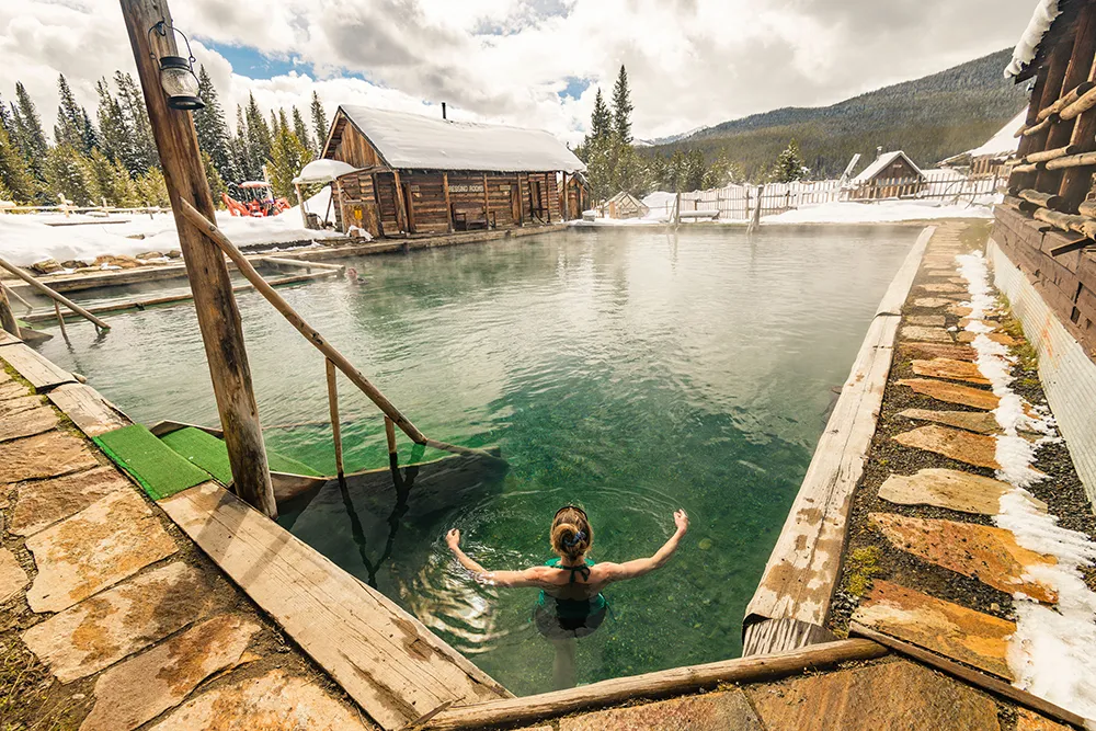 woman relaxing in Burgdorf hotspring pool during winter