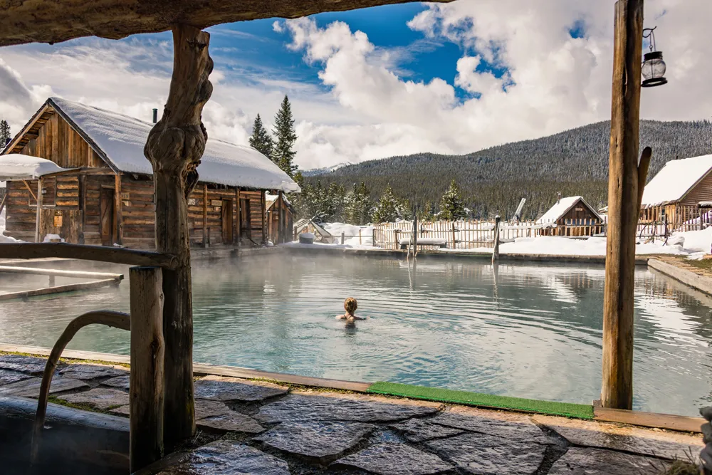 woman swimming in Burgdorf hotspring pool during winter